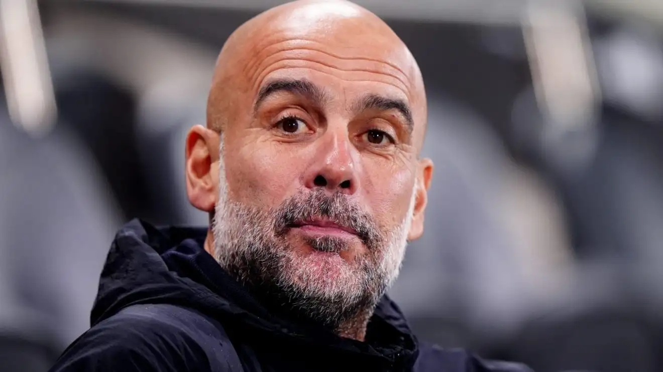 Man City manager Pep Guardiola looks on before a match